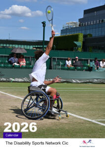 Shows a Wheelchair tennis player about to hit the tennis ball in a serve